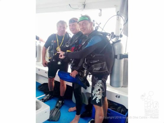 PADI Drift Divers getting ready to enter water off the back of the boat