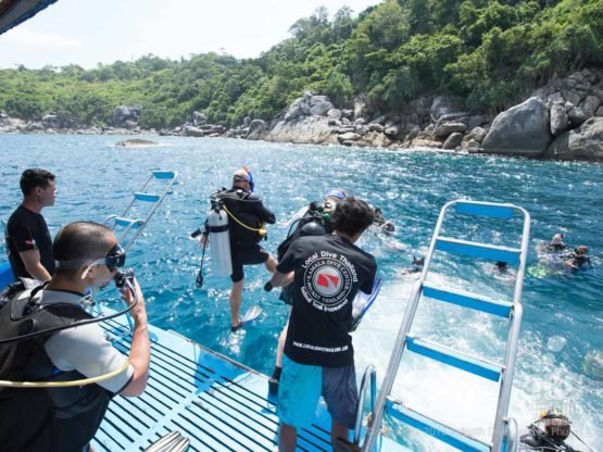 Phuket Dive Trip Boat 1: PADI Scuba Divers entering the water at Racha Noi